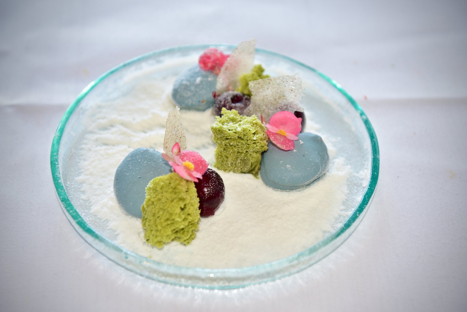 Japanese cherry blossom garden dark chocolate and yuzu ‘Namelaka’, macha Kasutera sponge, spiced cherries, sesame oil, blossom garnish